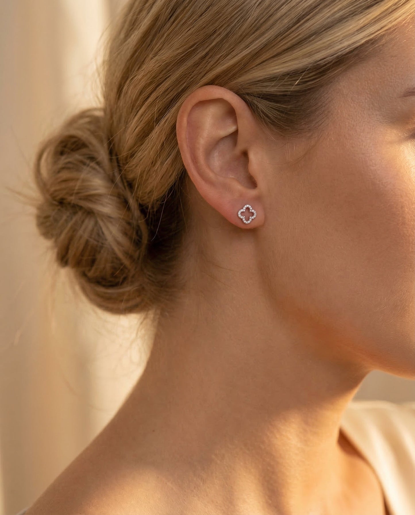 Clover Earrings — Loose bun, golden hour light, delicate clover stud